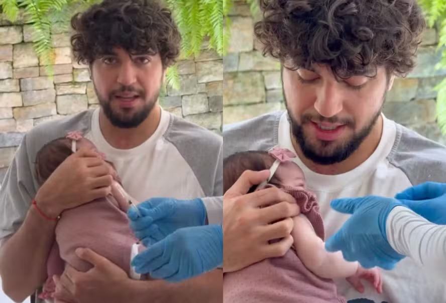 Zuza toma vacina no colo de Nattan, deixando Rafa Kalimann emocionada com o momento: ‘Tadinha’