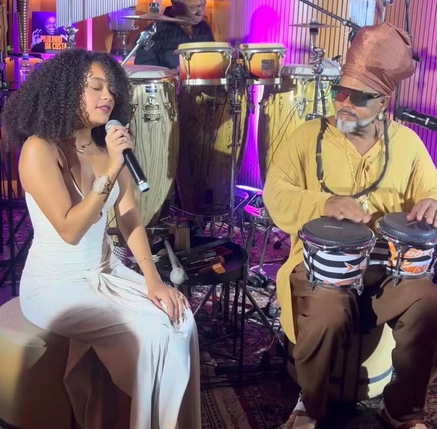 Aos 19, filha de Carlinhos Brown emociona ao cantar, com o pai, música do avô, Chico Buarque; assista