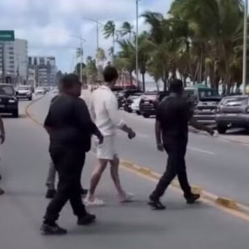 Chamado de ‘demônio da mandíbula hialurônica’ por Luana Piovani, influenciador vai à praia escoltado: ‘Doida de Portugal’